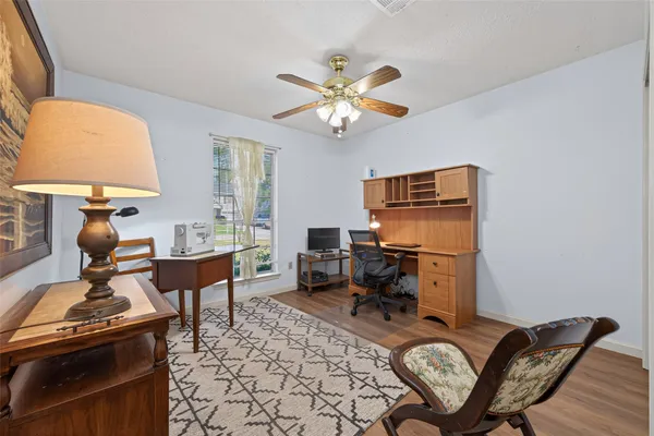a living room with furniture a piano and a lamp