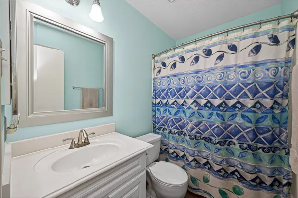 a bathroom with a sink and mirror with toilet