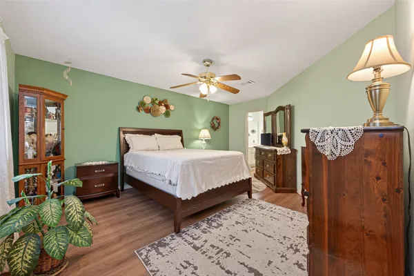 a bedroom with a bed and a chandelier