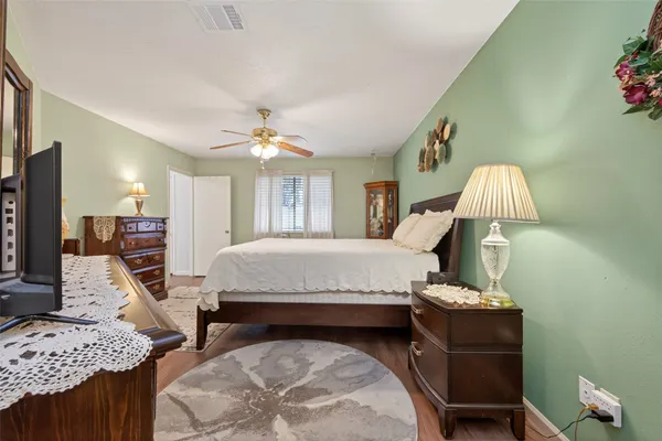 a bed room with a bed window and a chair