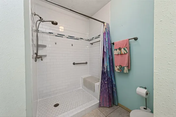 a bathroom with a shower and a toilet