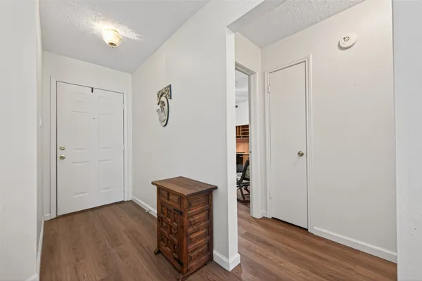 a view of empty room with wooden floor