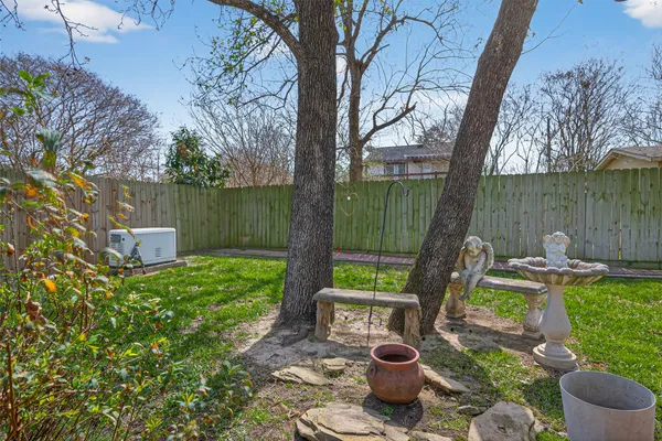 a view of a garden with furniture and a lake view