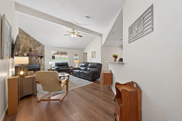 a living room with furniture and a wooden floor