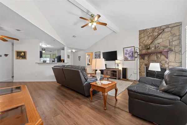 a living room with furniture and a view of kitchen