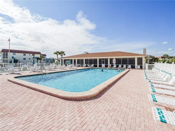 a view of swimming pool with lounge chair