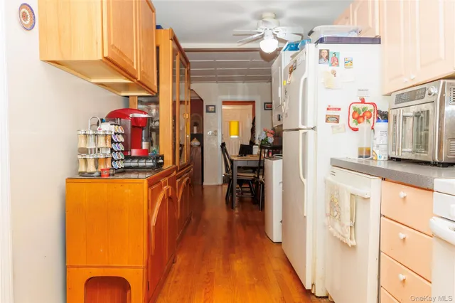 a kitchen with stainless steel appliances granite countertop a refrigerator a stove and a dining table view