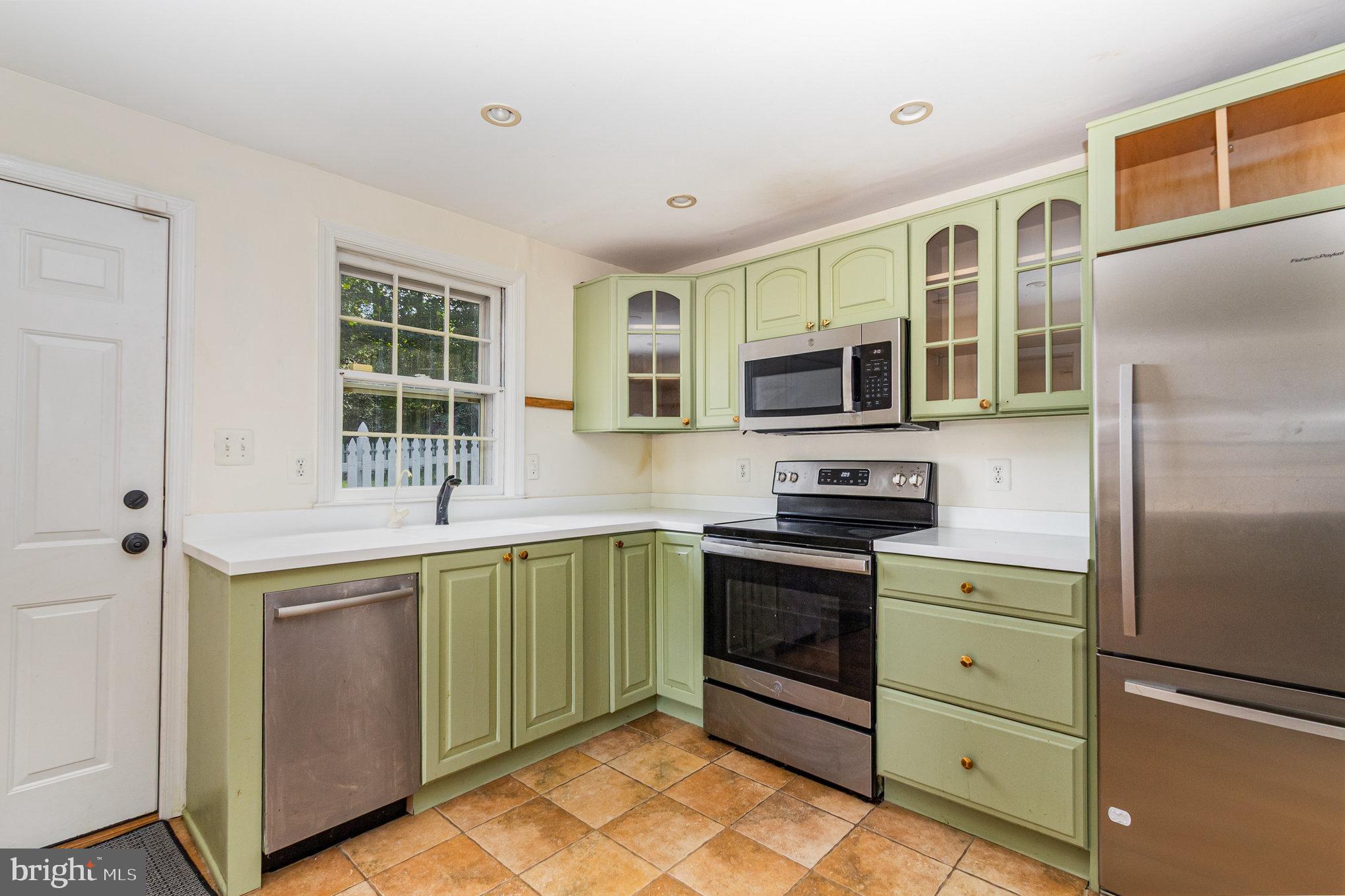 2304 Pickwick Road Baltimore, MD 21207 - Photo 11 of 37 a kitchen with stainless steel appliances granite countertop a stove and a refrigerator