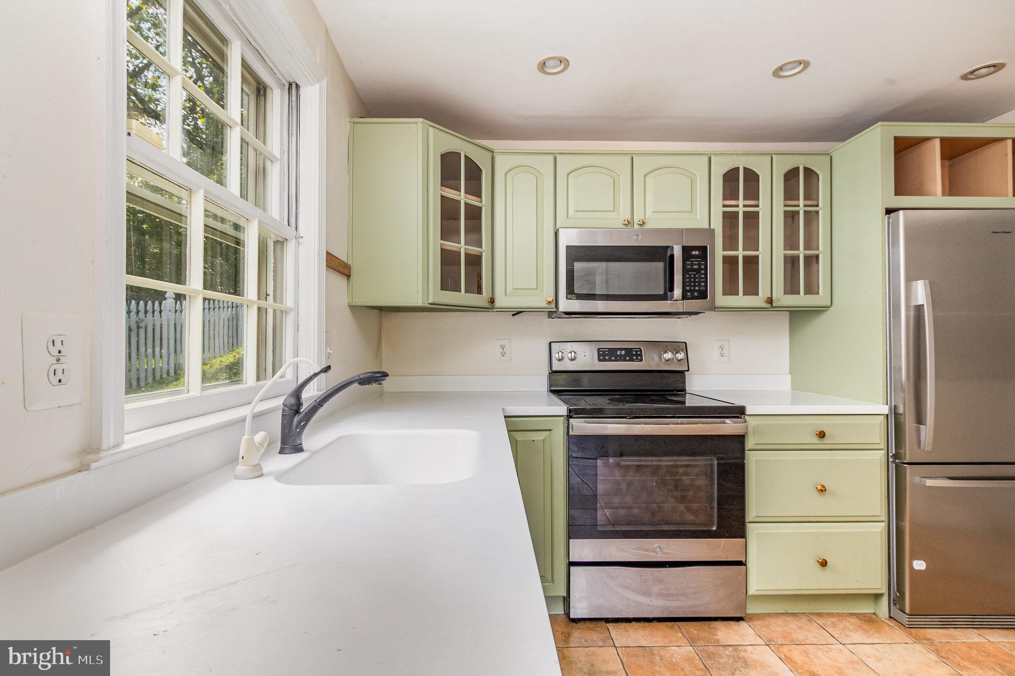 2304 Pickwick Road Baltimore, MD 21207 - Photo 12 of 37 a kitchen with a sink stove and microwave