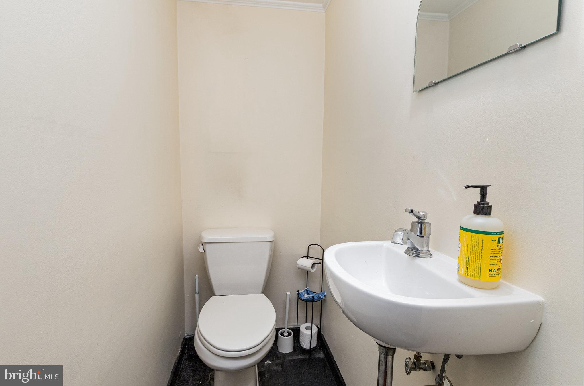 2304 Pickwick Road Baltimore, MD 21207 - Photo 15 of 37 a bathroom with a toilet sink and a mirror