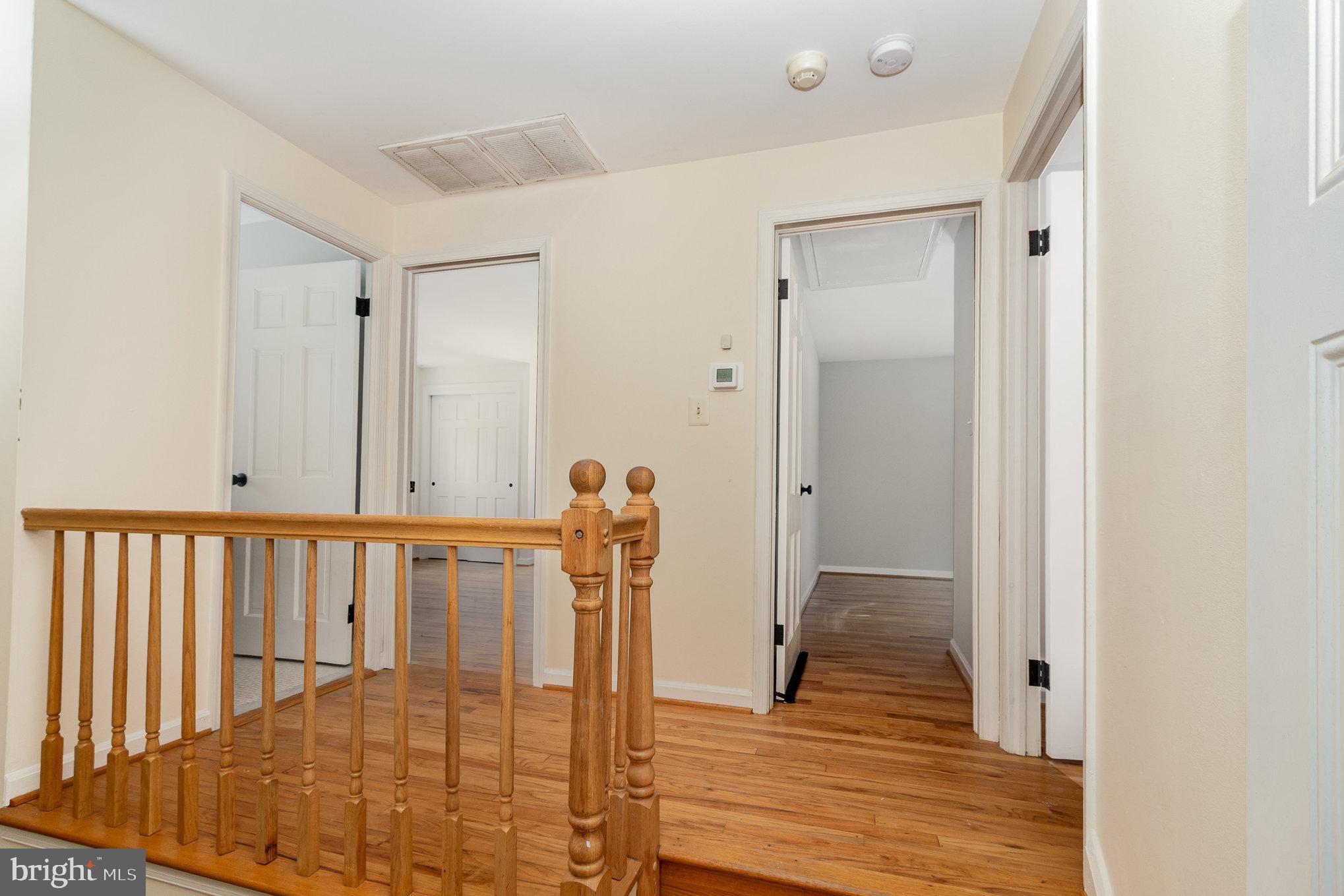 2304 Pickwick Road Baltimore, MD 21207 - Photo 16 of 37 a view of a hallway with wooden floor and staircase