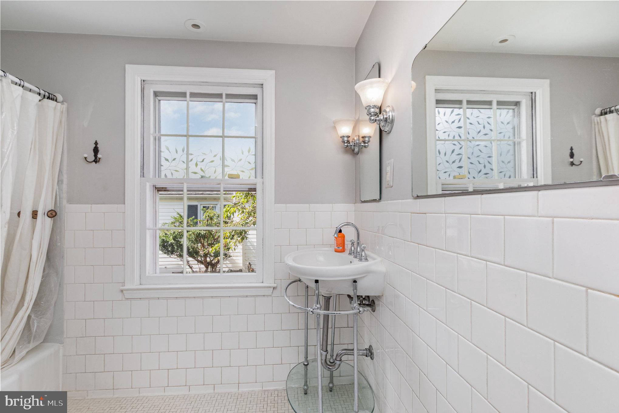 2304 Pickwick Road Baltimore, MD 21207 - Photo 23 of 37 a bathroom with a sink and a mirror