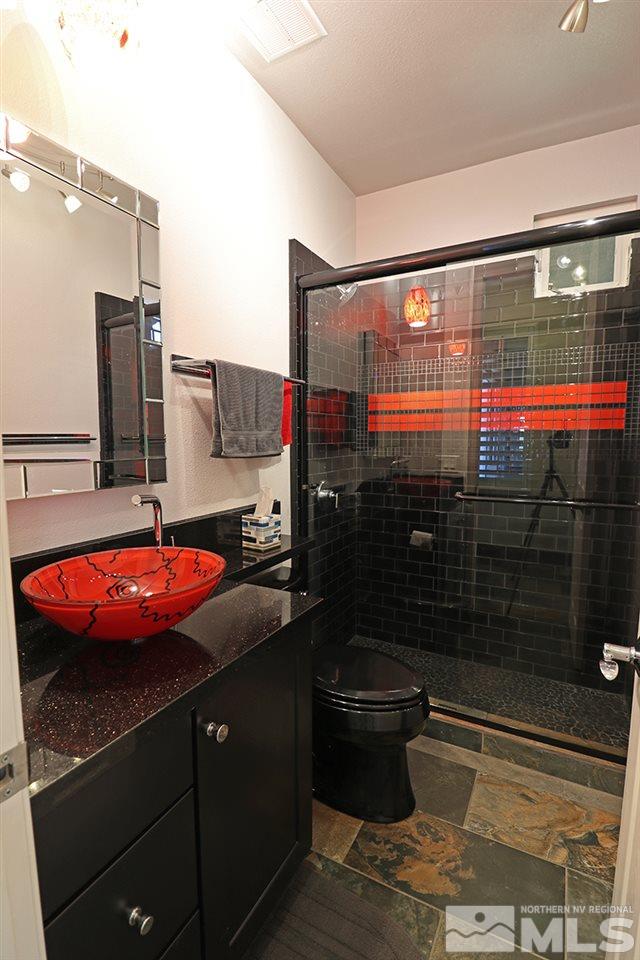 2655 Strathmore Court Reno, NV 89521 - Photo 12 of 38 a bathroom with a granite countertop sink and washing machine