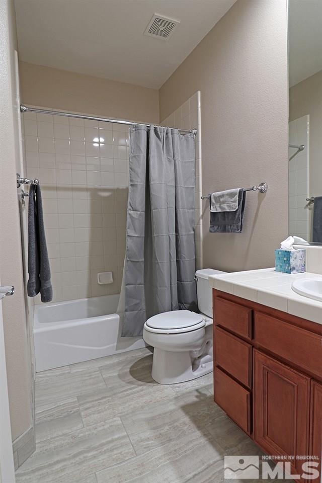 2655 Strathmore Court Reno, NV 89521 - Photo 18 of 38 a bathroom with a sink a toilet and shower