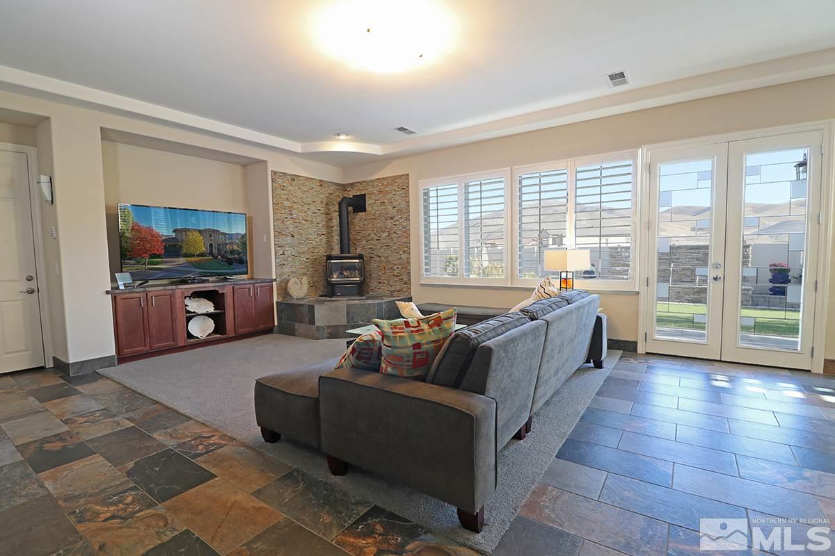 2655 Strathmore Court Reno, NV 89521 - Photo 2 of 38 a living room with furniture and a flat screen tv