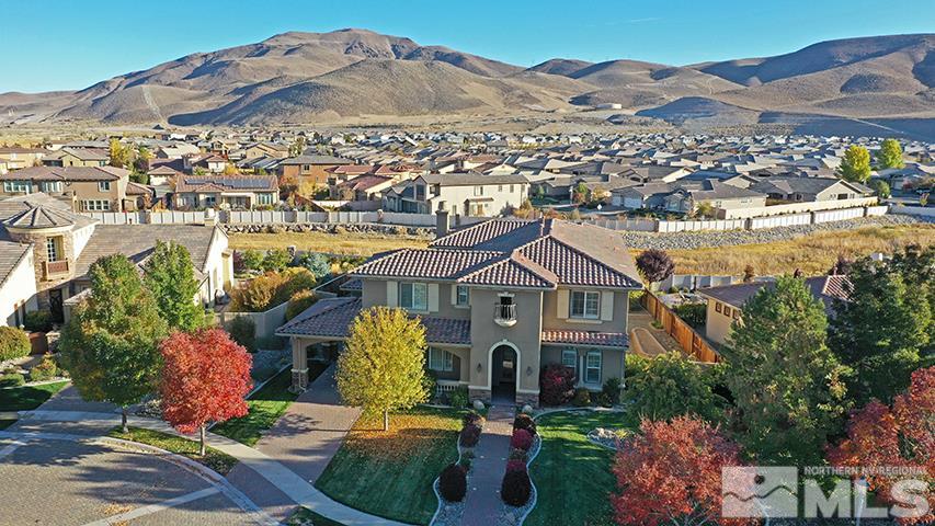 2655 Strathmore Court Reno, NV 89521 - Photo 24 of 38 a front view of a house with a garden and lake view