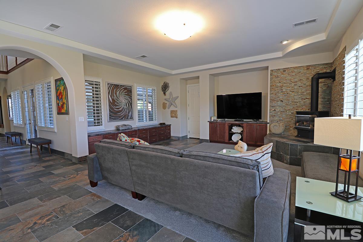 2655 Strathmore Court Reno, NV 89521 - Photo 3 of 38 a living room with furniture and a flat screen tv