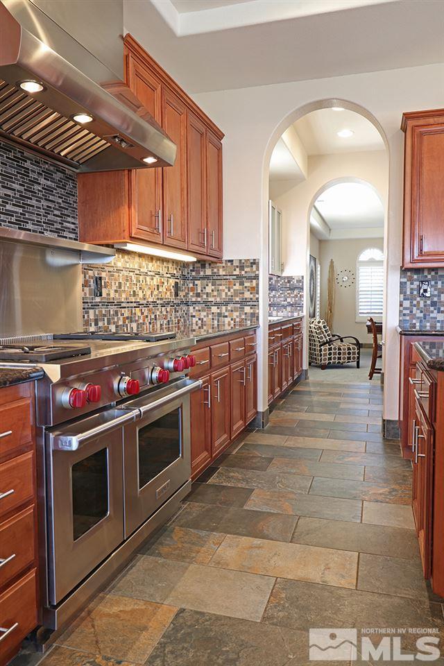 2655 Strathmore Court Reno, NV 89521 - Photo 7 of 38 a kitchen with stainless steel appliances and stove top oven