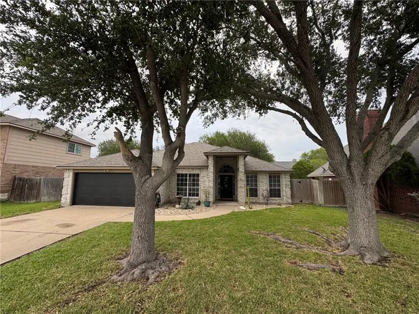 a front view of house with yard and green space