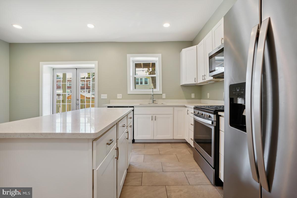 37 Michigan Avenue Northeast Washington, DC 20002 - Photo 13 of 31 a kitchen with stainless steel appliances granite countertop a refrigerator sink and stove