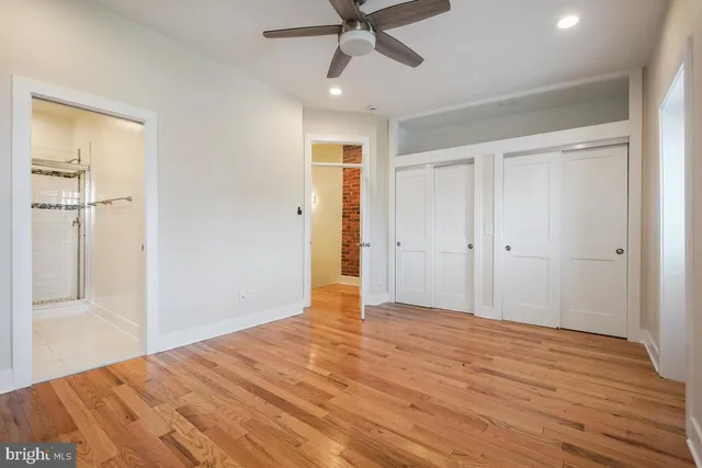 a view of empty room with wooden floor