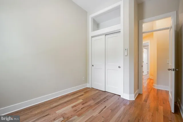 a view of a room with wooden floor and a gate