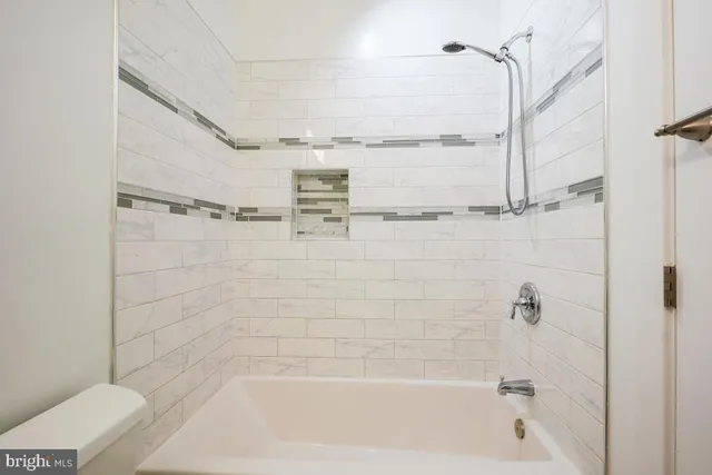 a bathroom with a shower and a bathtub