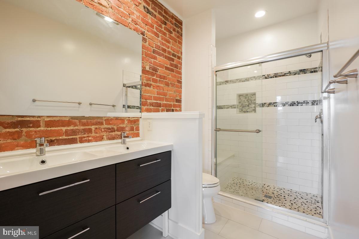 37 Michigan Avenue Northeast Washington, DC 20002 - Photo 25 of 31 a bathroom with a shower sink and mirror