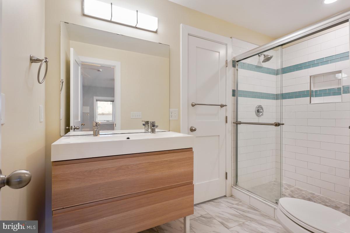 37 Michigan Avenue Northeast Washington, DC 20002 - Photo 29 of 31 a bathroom with a sink and mirror with toilet