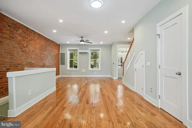 wooden floor in an empty room with a window
