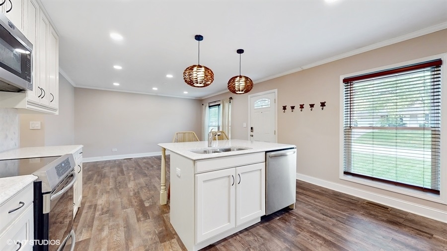 2321 Spring Hill Lane Lindenhurst, IL 60046 - Photo 11 of 30 a kitchen with a sink dishwasher and a stove with wooden floor