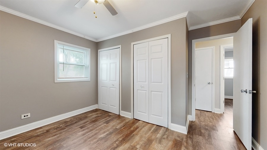 2321 Spring Hill Lane Lindenhurst, IL 60046 - Photo 13 of 30 a view of an empty room with window and wooden floor