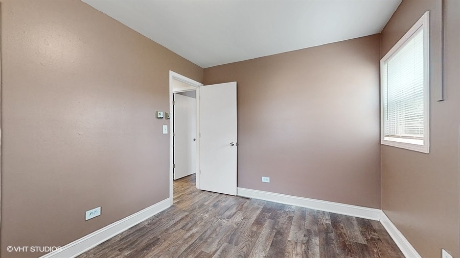 2321 Spring Hill Lane Lindenhurst, IL 60046 - Photo 16 of 30 an empty room with wooden floor and windows