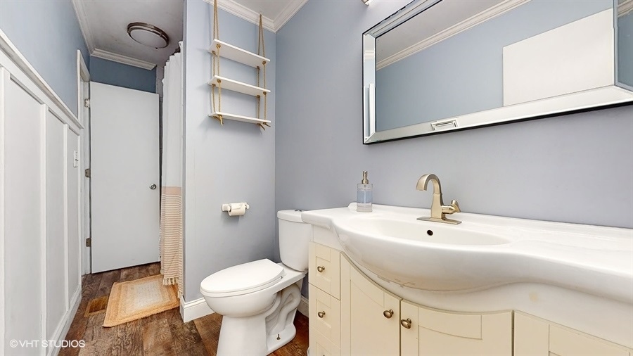 2321 Spring Hill Lane Lindenhurst, IL 60046 - Photo 19 of 30 a bathroom with a sink a toilet and a mirror