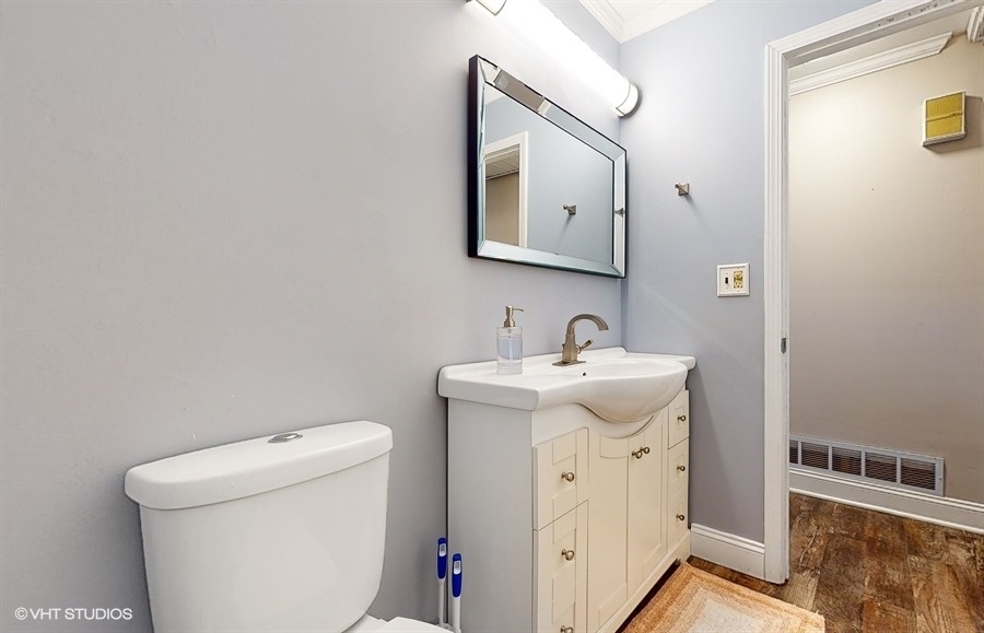 2321 Spring Hill Lane Lindenhurst, IL 60046 - Photo 21 of 30 a bathroom with a toilet sink and mirror