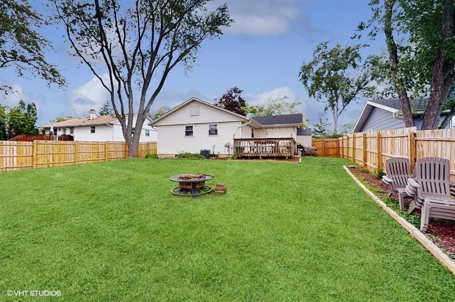 2321 Spring Hill Lane Lindenhurst, IL 60046 - Photo 28 of 30 a front view of a house with a yard and trees
