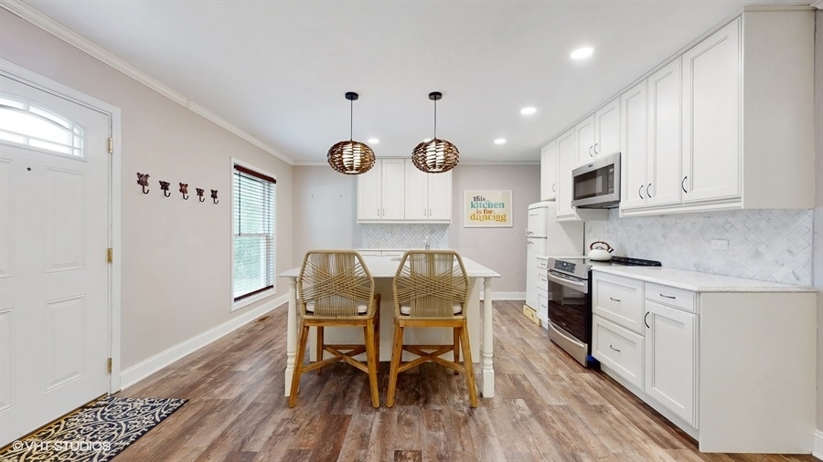 2321 Spring Hill Lane Lindenhurst, IL 60046 - Photo 7 of 30 a view of kitchen with cabinets and wooden floor