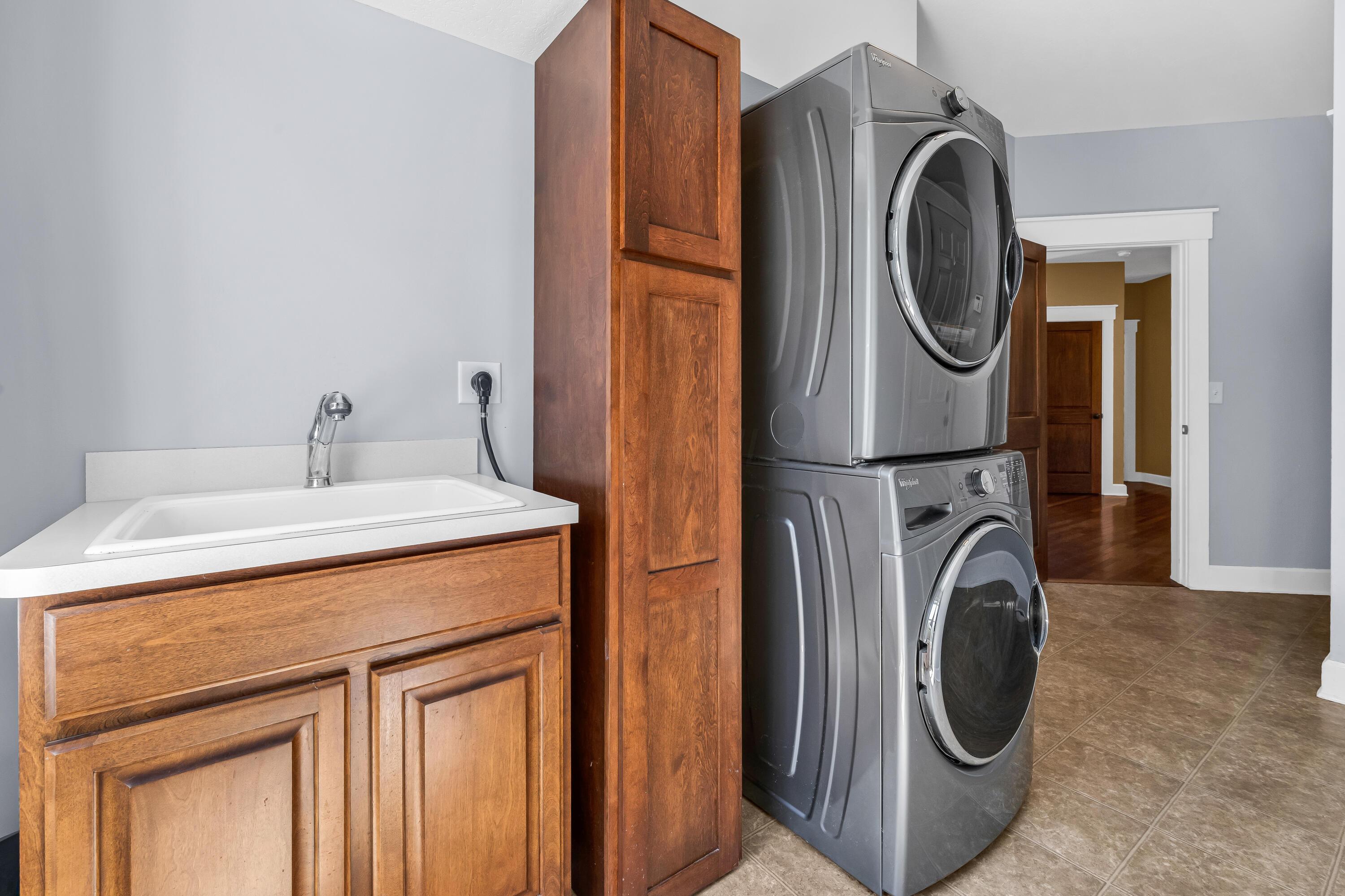 16689 Bailor Road Laurelville, OH 43135 - Photo 16 of 73 Neutral vinyl flooring
• Grey painted walls
• Wall cabinets remain
• Ceiling light
• Washer & dryer are
negotiable
• Enclosed utility sink
• Electric dryer hookup
• Drapes remain
• Closet with double
sliding door