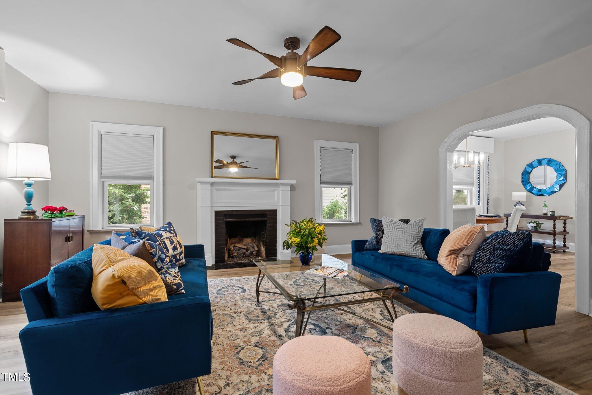 3215 Merriman Avenue Raleigh, NC 27607 - Photo 13 of 66 a living room with furniture a fireplace and a large window