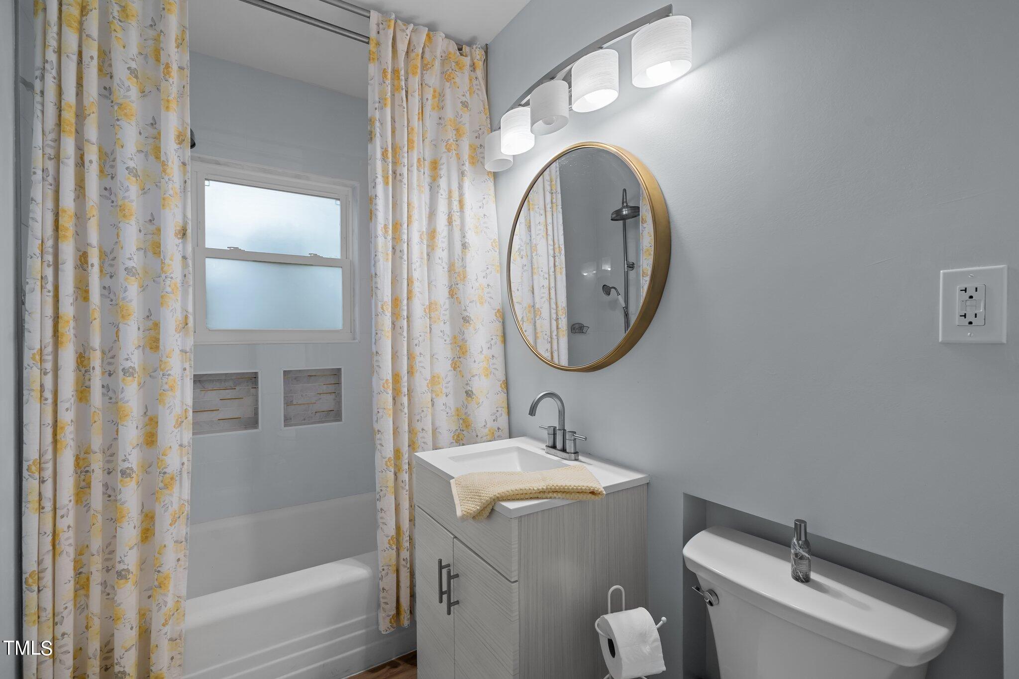 3215 Merriman Avenue Raleigh, NC 27607 - Photo 25 of 66 a bathroom with a toilet sink vanity tub and mirror