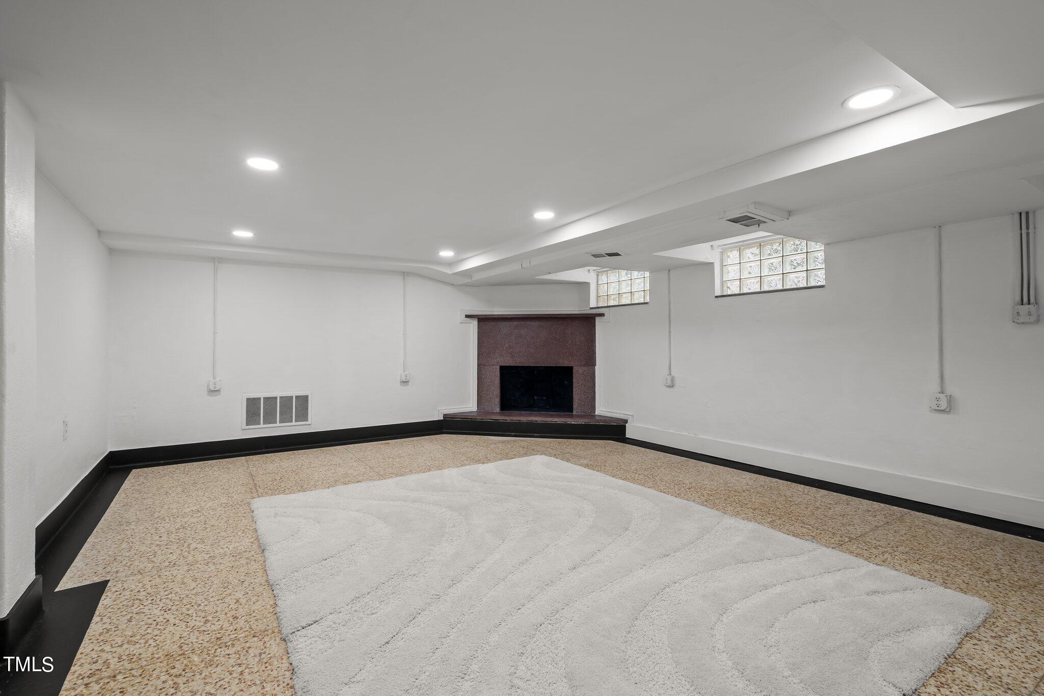 3215 Merriman Avenue Raleigh, NC 27607 - Photo 37 of 66 a view of an empty room with a fireplace and a window