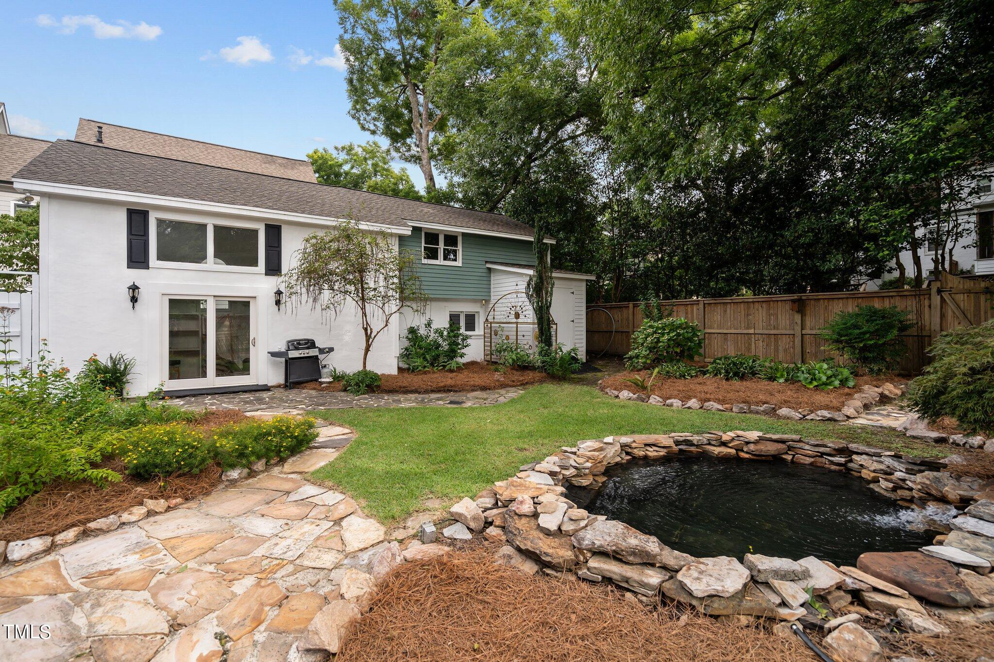 3215 Merriman Avenue Raleigh, NC 27607 - Photo 47 of 66 a front view of a house with a garden and yard