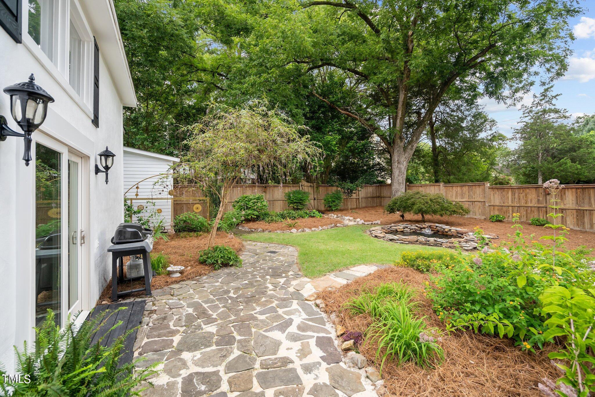 3215 Merriman Avenue Raleigh, NC 27607 - Photo 48 of 66 a view of a backyard with table and chairs and potted plants