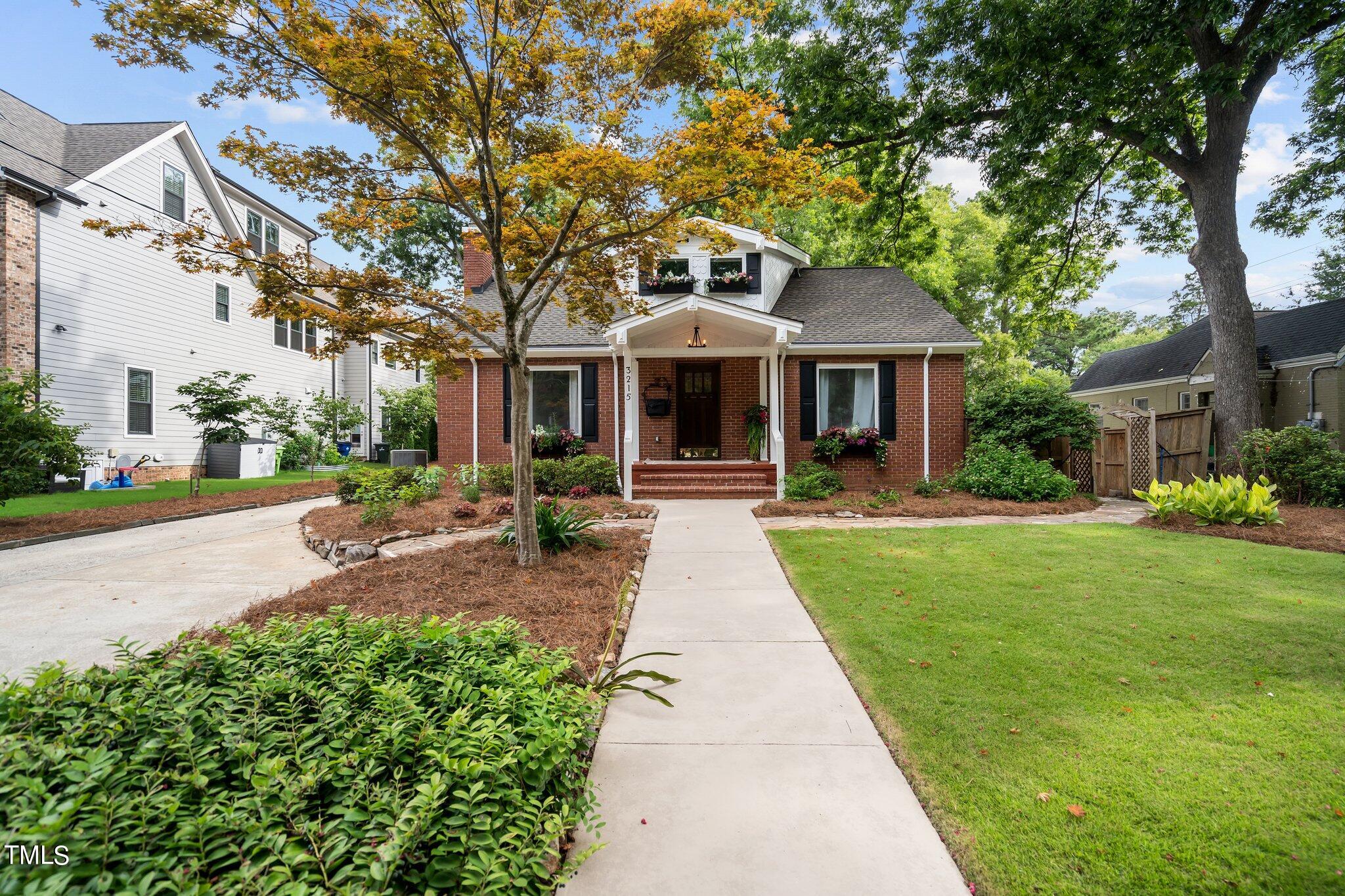 3215 Merriman Avenue Raleigh, NC 27607 - Photo 5 of 66 a front view of a house with yard and green space