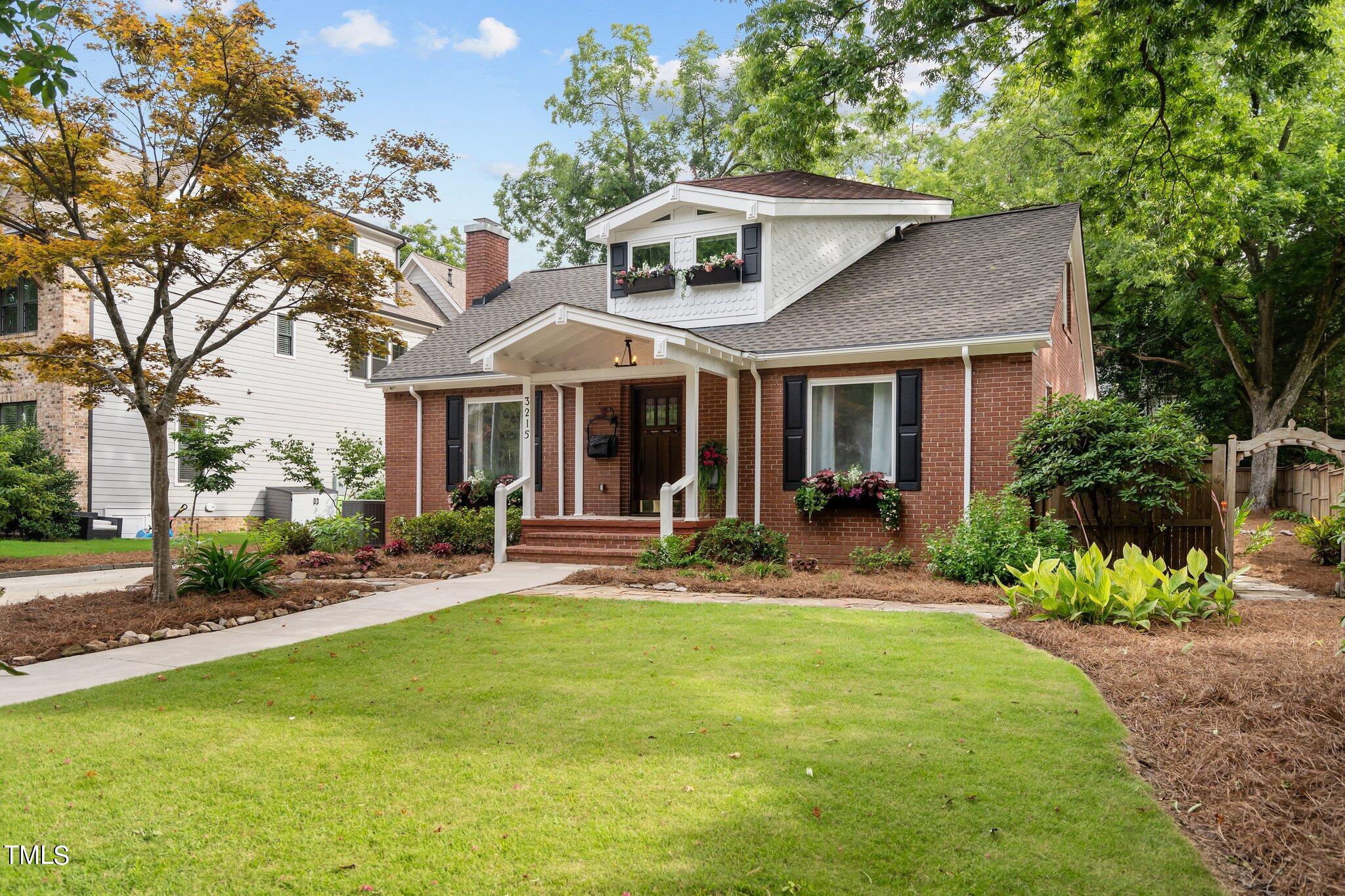 3215 Merriman Avenue Raleigh, NC 27607 - Photo 53 of 66 a front view of a house with a garden and trees