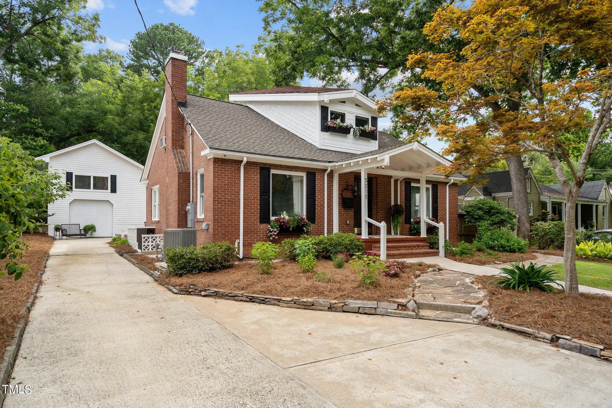 3215 Merriman Avenue Raleigh, NC 27607 - Photo 6 of 66 a front view of a house with yard and green space