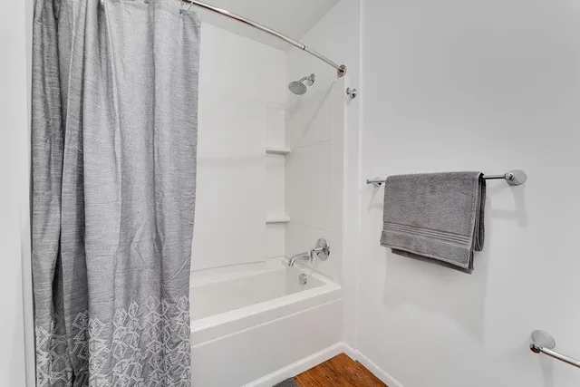a bathroom with a shower curtain and a bath tub