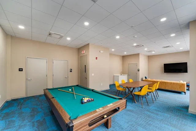 a living room with furniture pool and flat screen tv