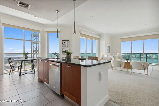 a kitchen with stainless steel appliances granite countertop a sink and a stove