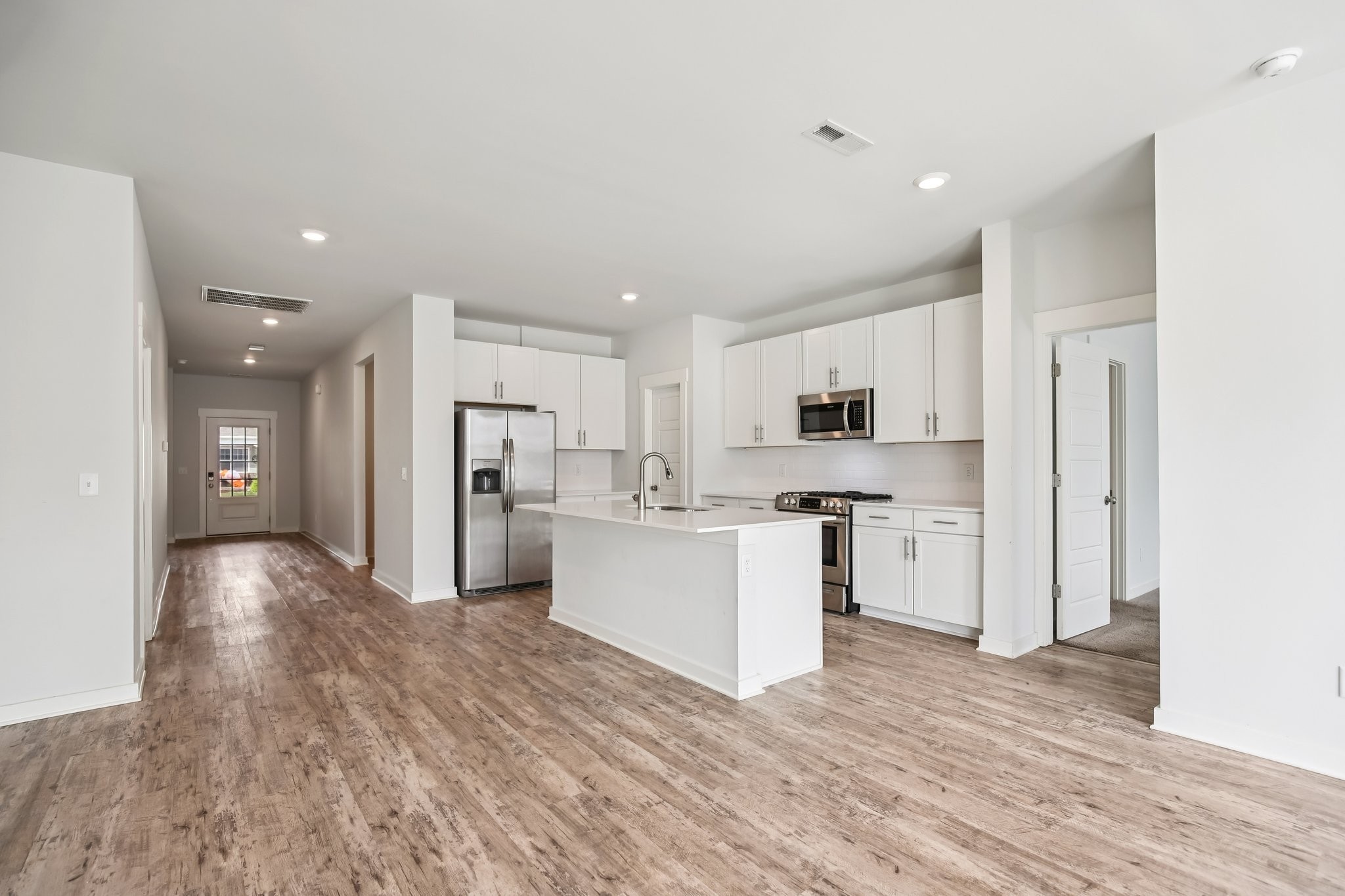 403 Wind Dance Drive Lebanon, TN 37087 - Photo 13 of 66 a kitchen with white cabinets and stainless steel appliances